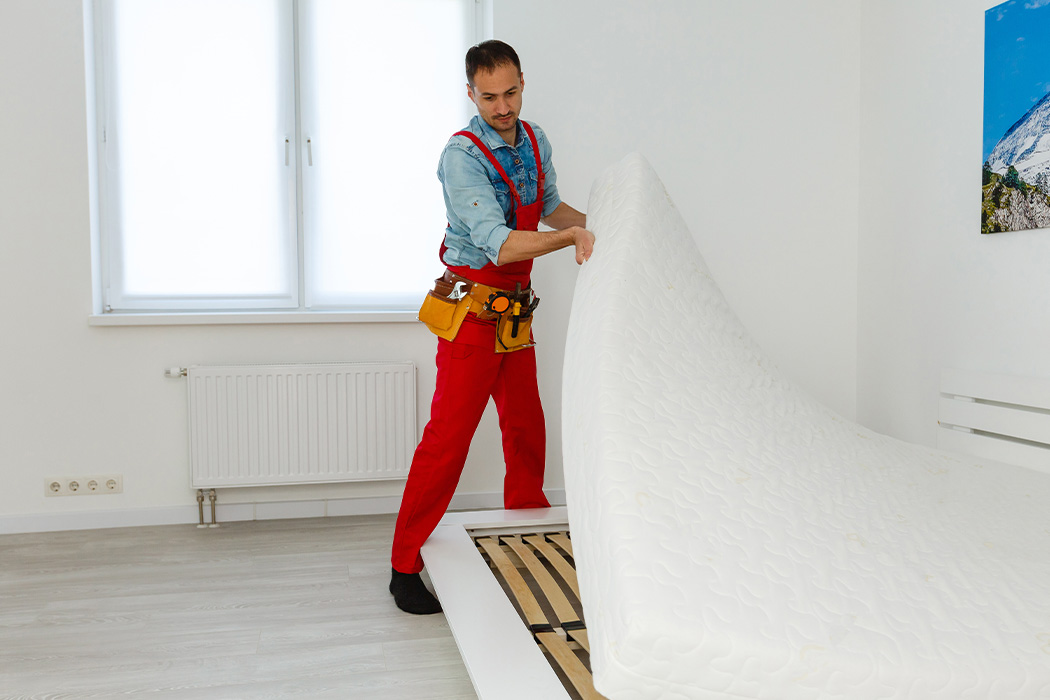A Mover Is Disassembling A King-size Bed